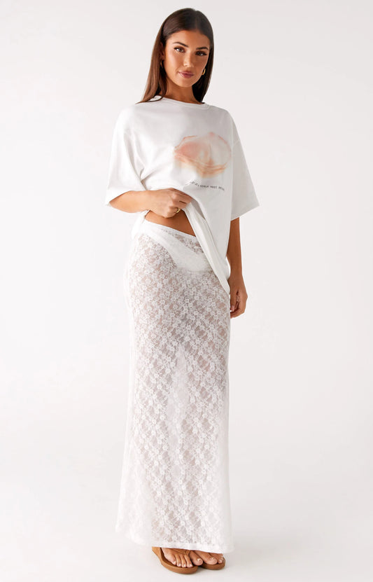A woman wearing a white top and pink skirt from Peppermayo US women's bottoms collection