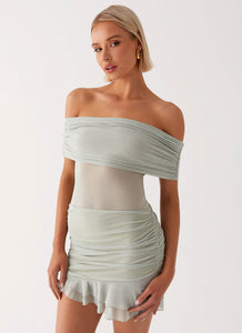 Womens Nelly Off Shoulder Mini Dress in the colour Pistachio in front of a light grey background
