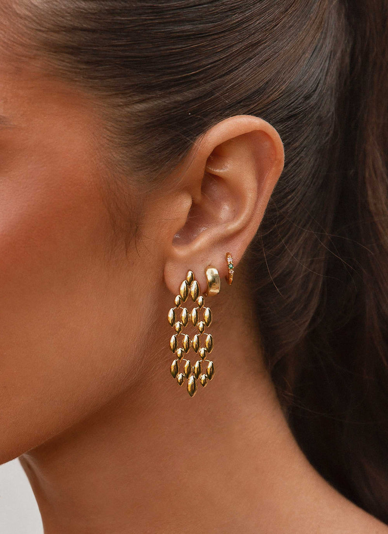 Womens Fireside Gold Earrings in the colour Gold in front of a light grey background