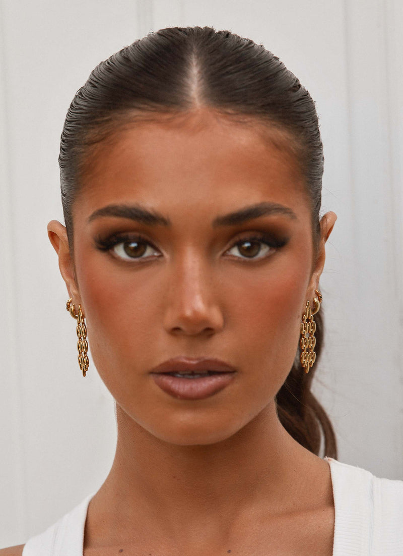 Womens Fireside Gold Earrings in the colour Gold in front of a light grey background