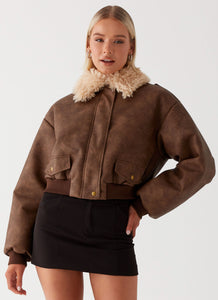 Womens Aston Shearling Bomber Jacket in the colour Brown in front of a light grey background