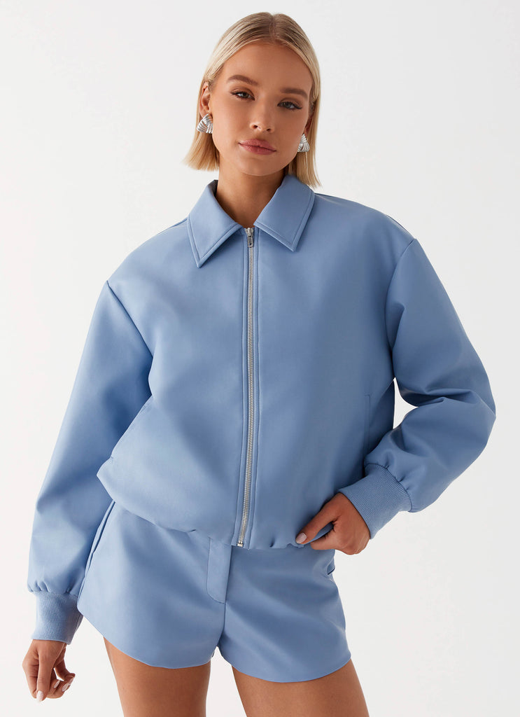 Womens Aspen Oversized Bomber Jacket in the colour Blue in front of a light grey background