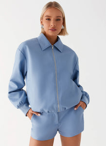 Womens Aspen Oversized Bomber Jacket in the colour Blue in front of a light grey background