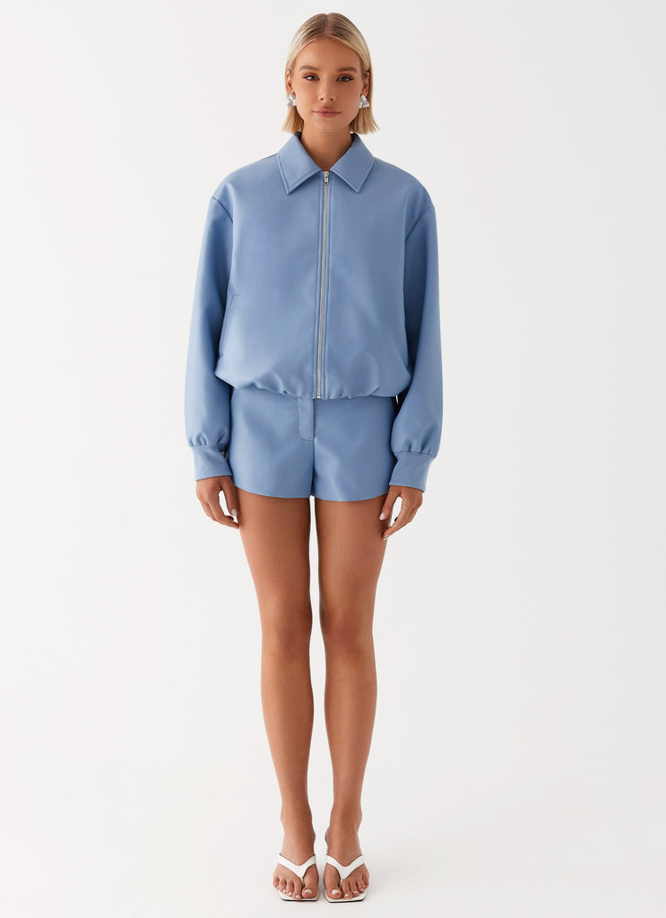 Womens Aspen Oversized Bomber Jacket in the colour Blue in front of a light grey background