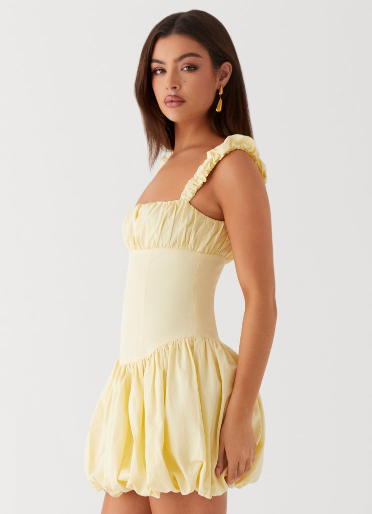 Womens Clove Mini Dress in the colour Yellow in front of a light grey background