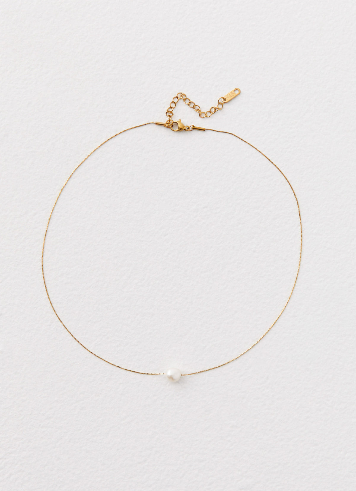 Womens Heartstrings Pearl Necklace in the colour Ivory in front of a light grey background