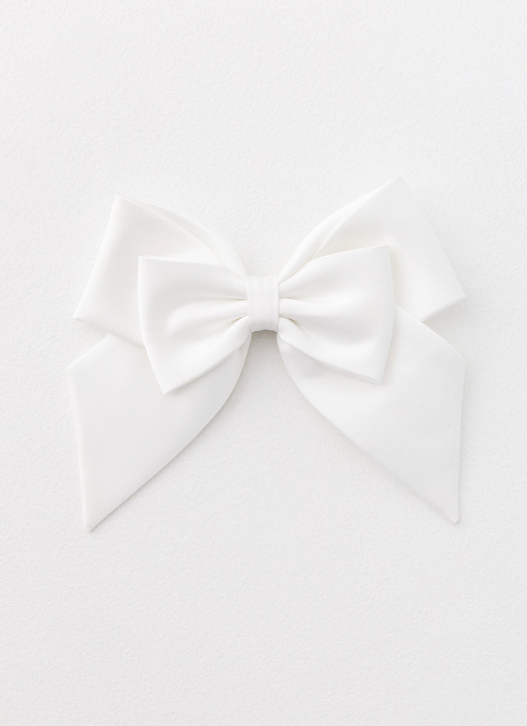 Womens Lucky In Love Bow Hair Clip in the colour White in front of a light grey background