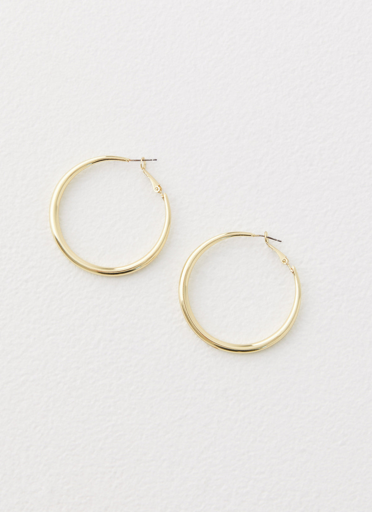 Womens Mutual Feelings Earrings in the colour Gold in front of a light grey background
