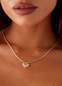 Womens Pending Heart Necklace in the colour Gold in front of a light grey background