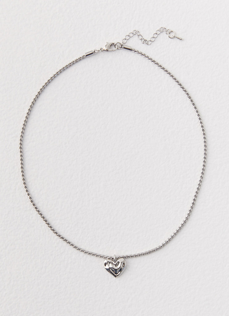 Womens Pending Heart Necklace in the colour Silver in front of a light grey background