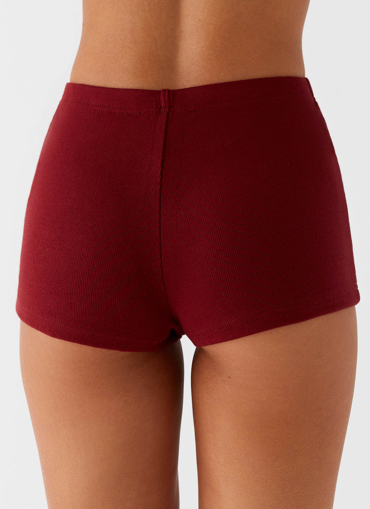 Womens Spectate Mini Shorts in the colour Maroon in front of a light grey background