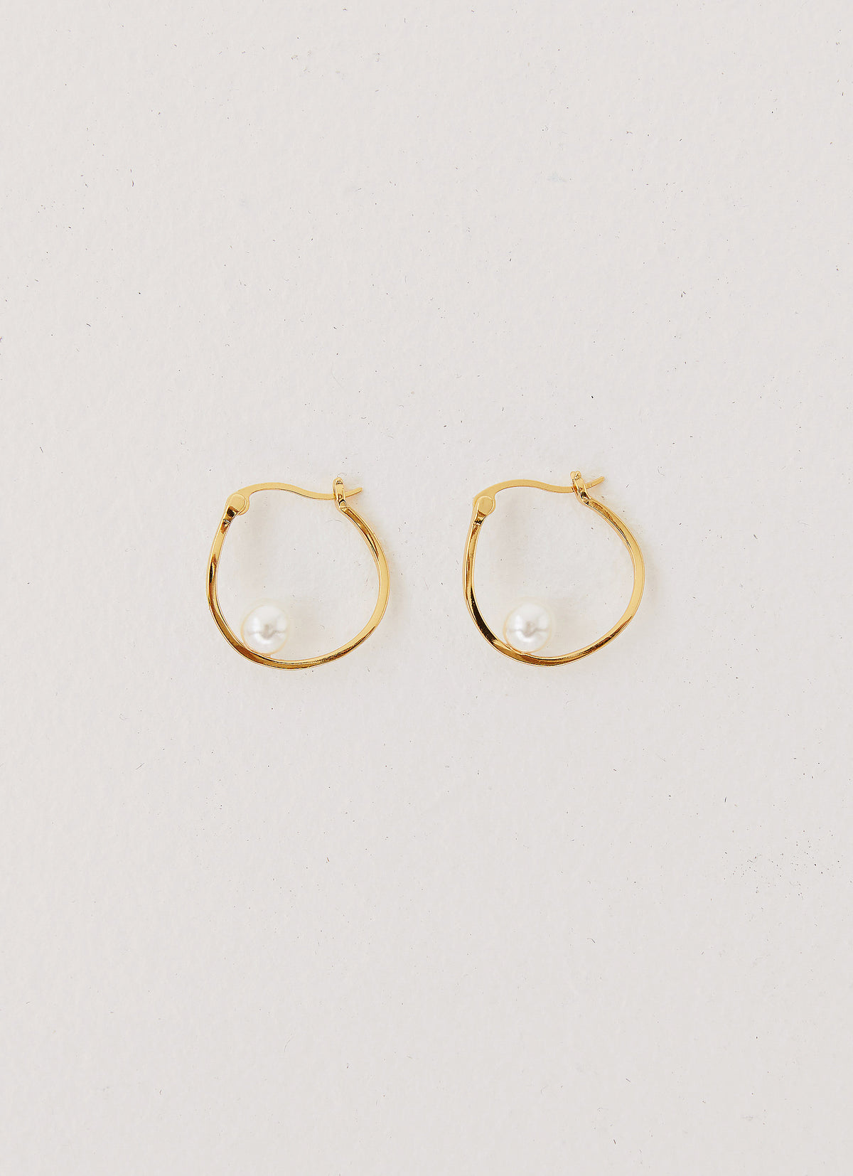 Womens Cosima Abstract Hoop Earring in the colour Gold in front of a light grey background