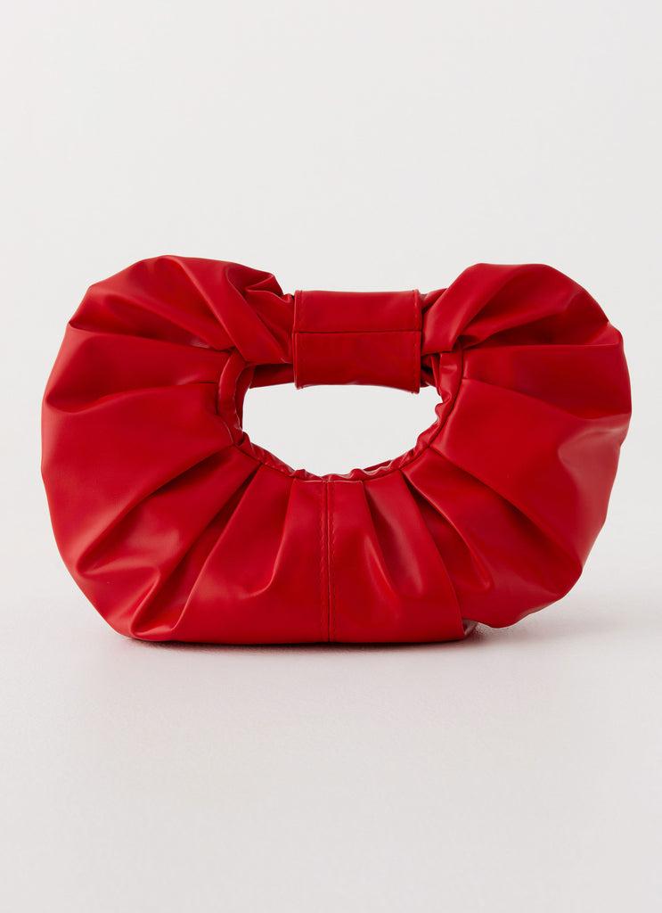 Womens Atavista Scrunchie Bag in the colour Red in front of a light grey background