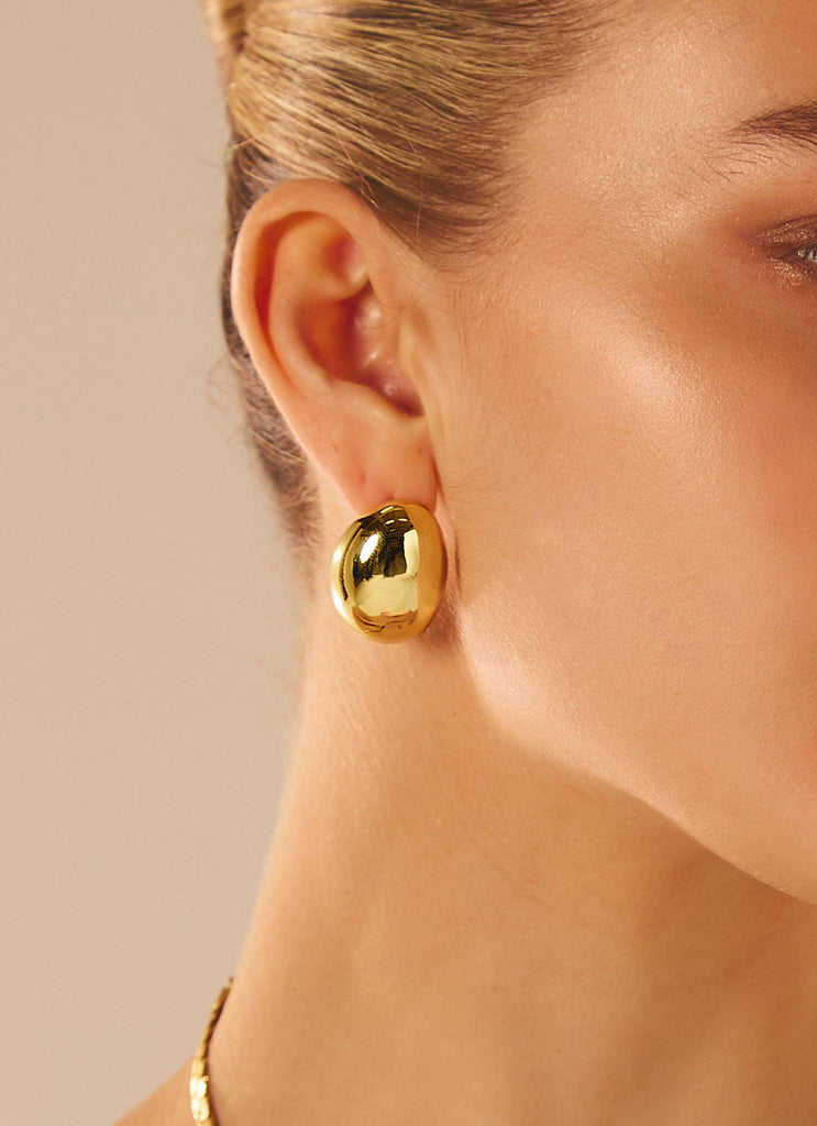 Womens No Pressure Large Chunky Earrings in the colour Gold in front of a light grey background